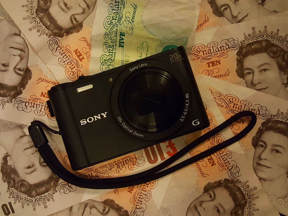 Camera Sony Cybershot WX350 on an array of British money